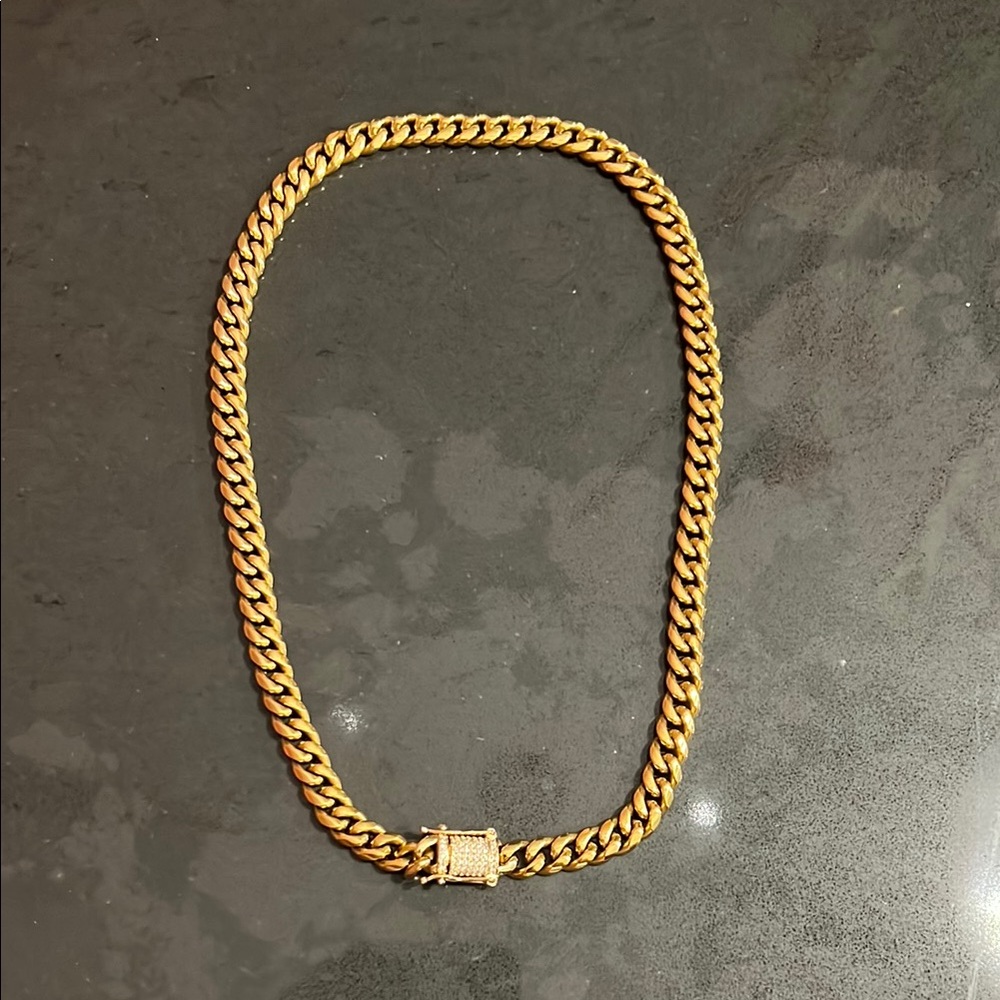 Gold chain link necklace with a rhinestone studded fastening